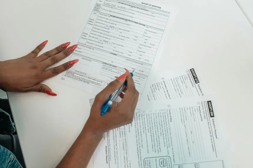Person filling out insurance claim paperwork